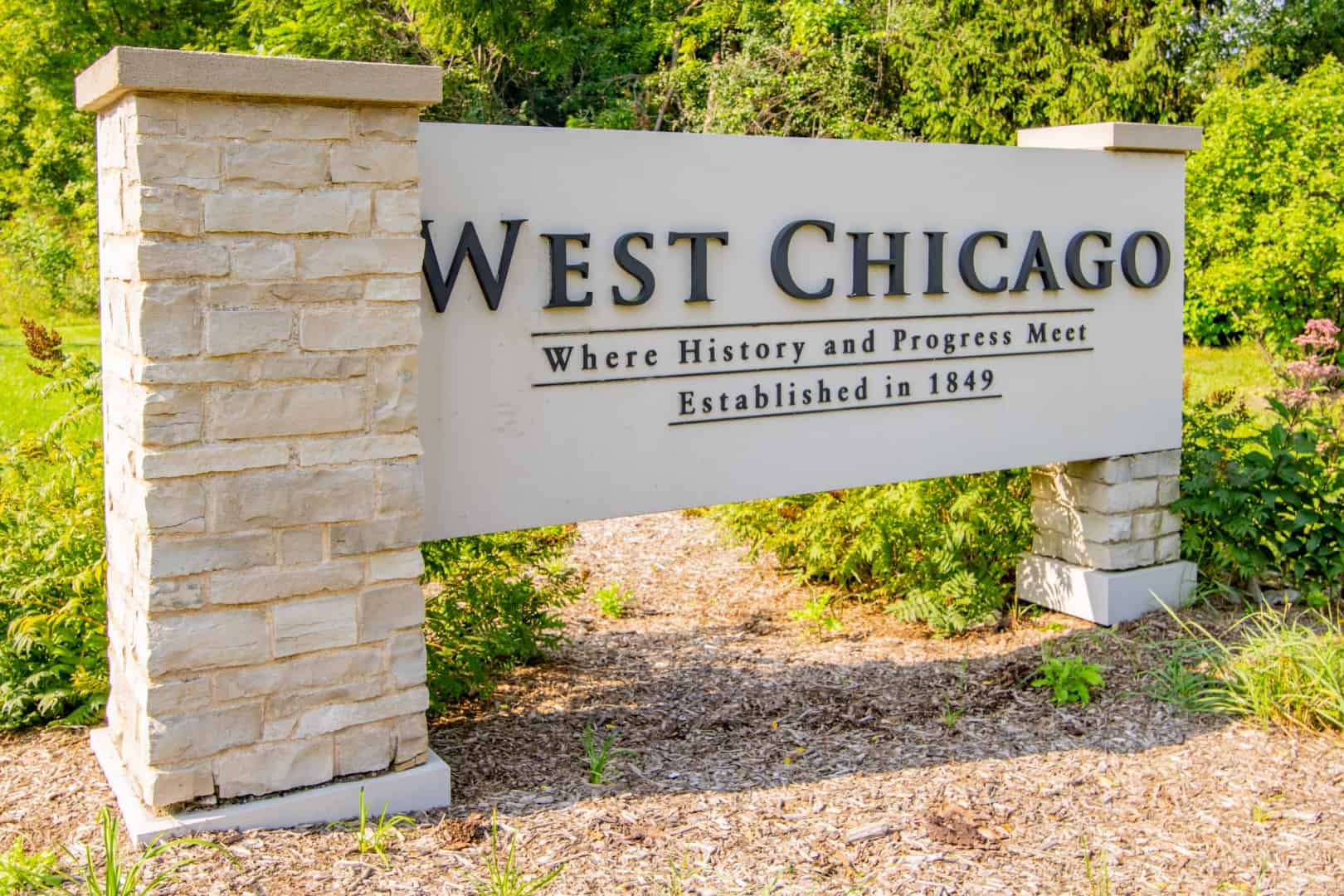 Welcome sign for West Chicago, Illinois, established in 1849, with the motto 'Where History and Progress Meet.'